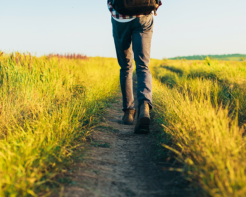 Man walking though a field after inner child healing